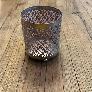 Silver toned metal laser cutout candle holder with glass insert